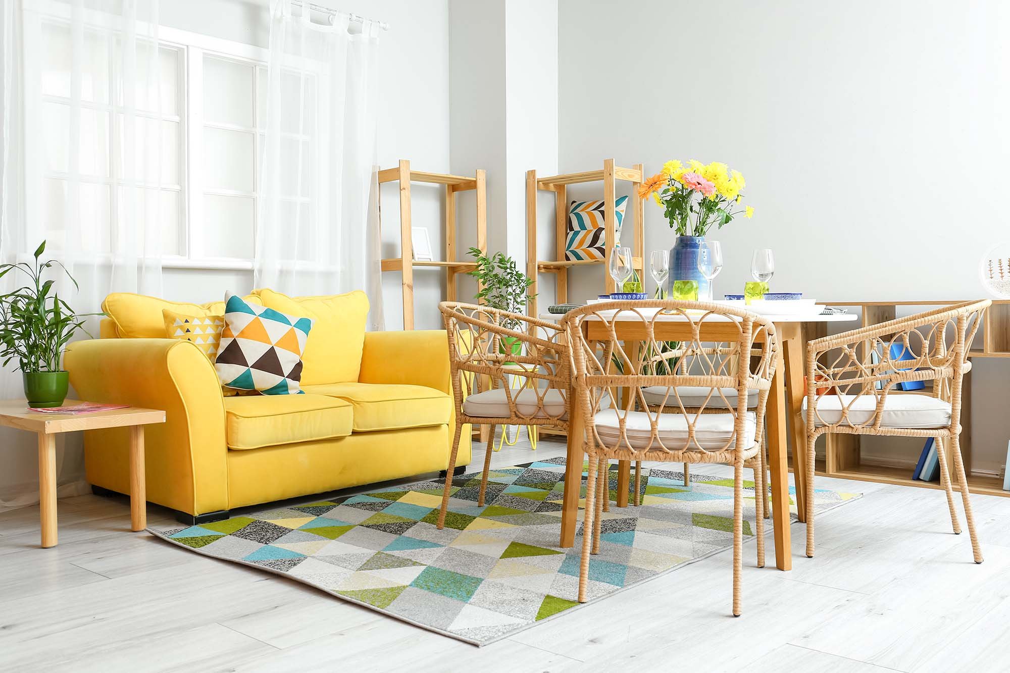 yellow couch on a color patterned are rug from Christie Carpets Flooring & Blinds in Rochester, NY